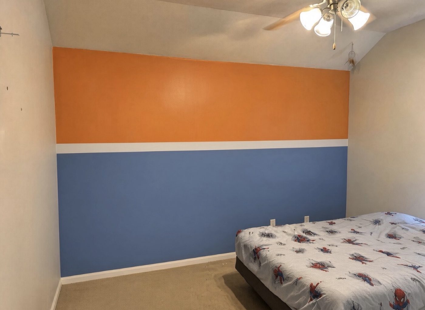 After - kids bedroom accent wall painted orange and blue with white stripe