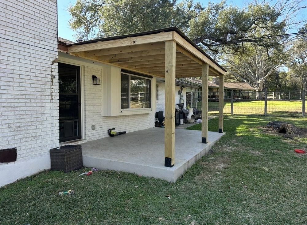 After - completed covered patio with wood posts and metal roof