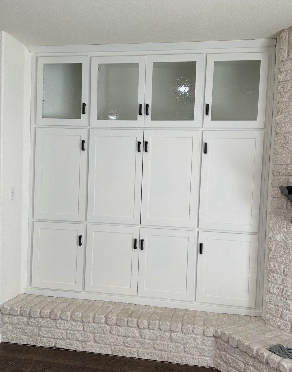 After - built-in entertainment center painted white with black hardware