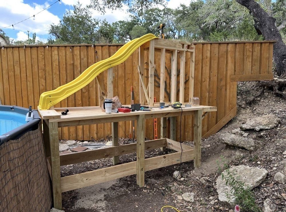 Before - poolside play structure framing under construction with tools
