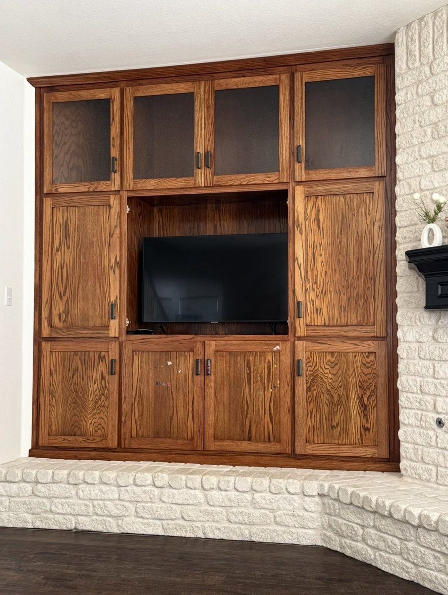 Before - stained oak built-in entertainment center with TV niche