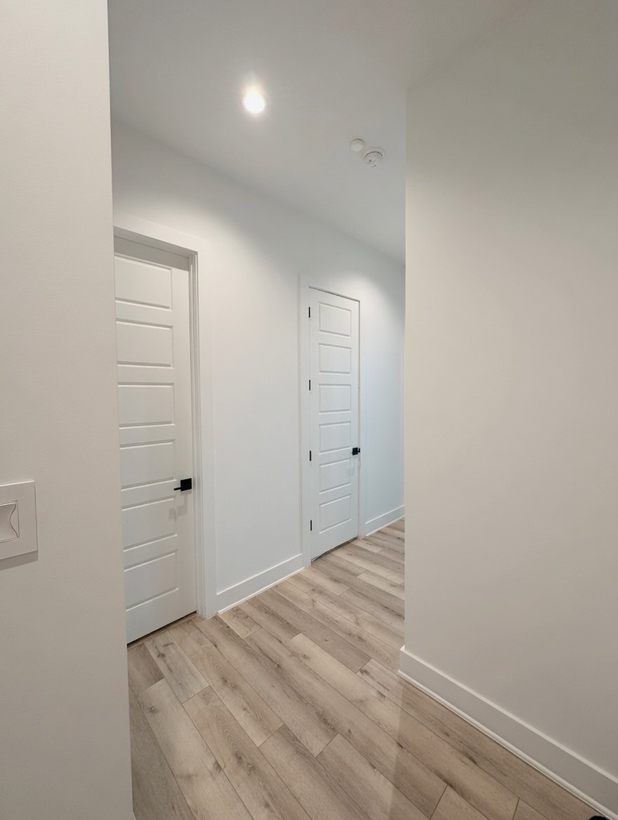 Before - plain white hallway walls before stripe paint