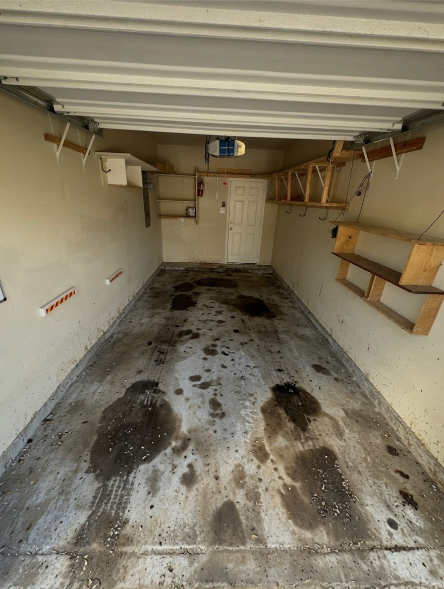 Before - stained dirty concrete garage floor with oil stains